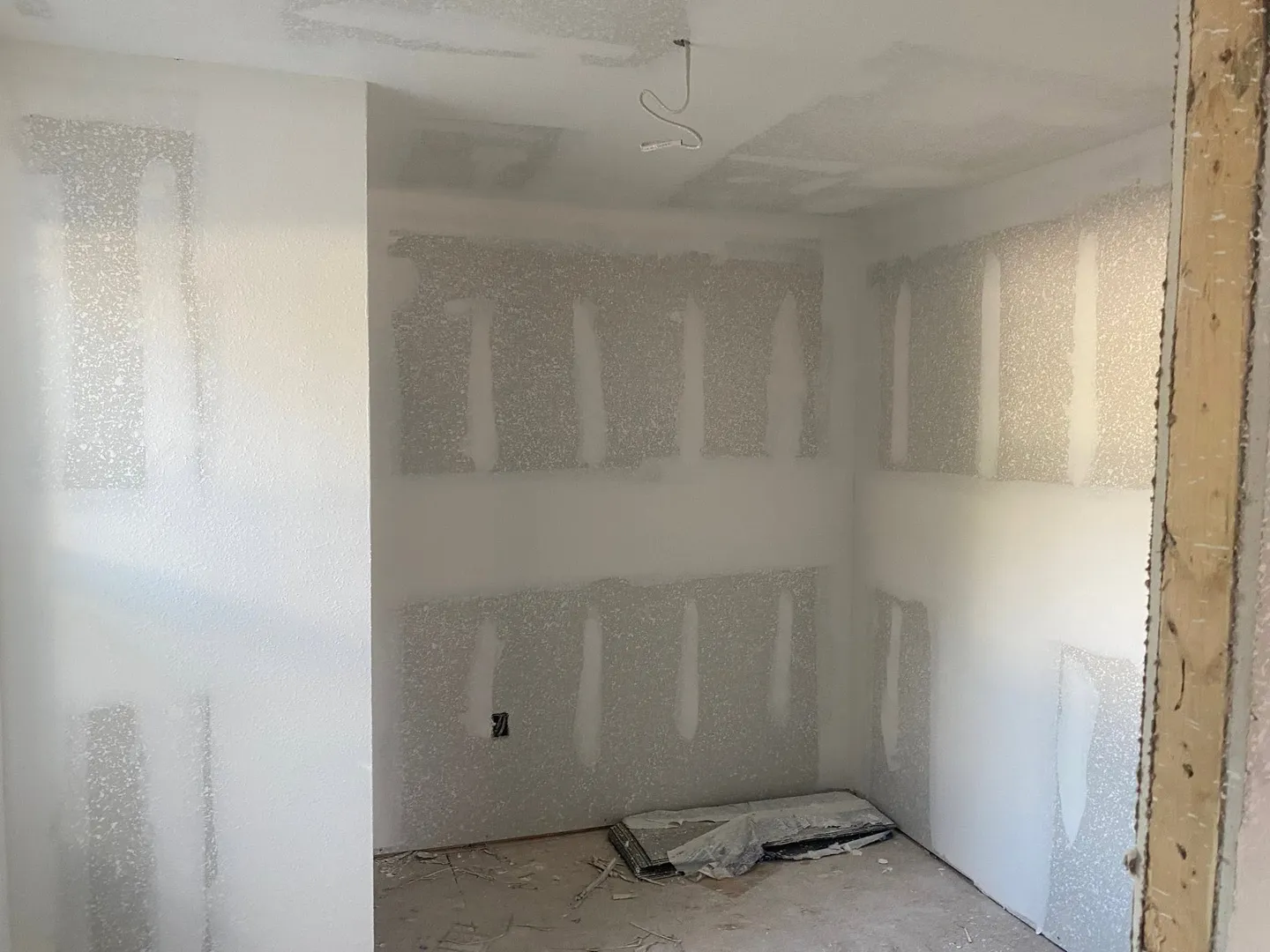 Interior drywall with seams and joint compound in progress.