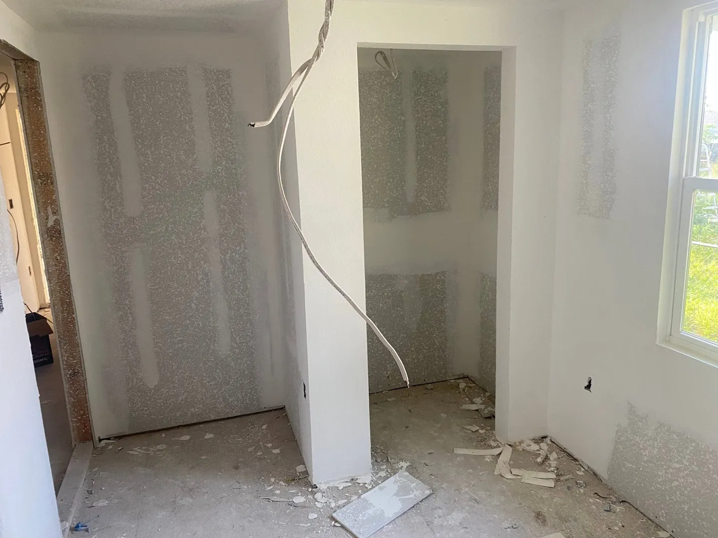 Interior drywall with seams and joint compound in progress.
