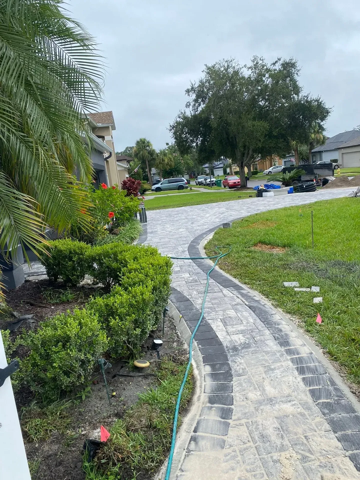 Paver driveway and walkway at different stages of the project.