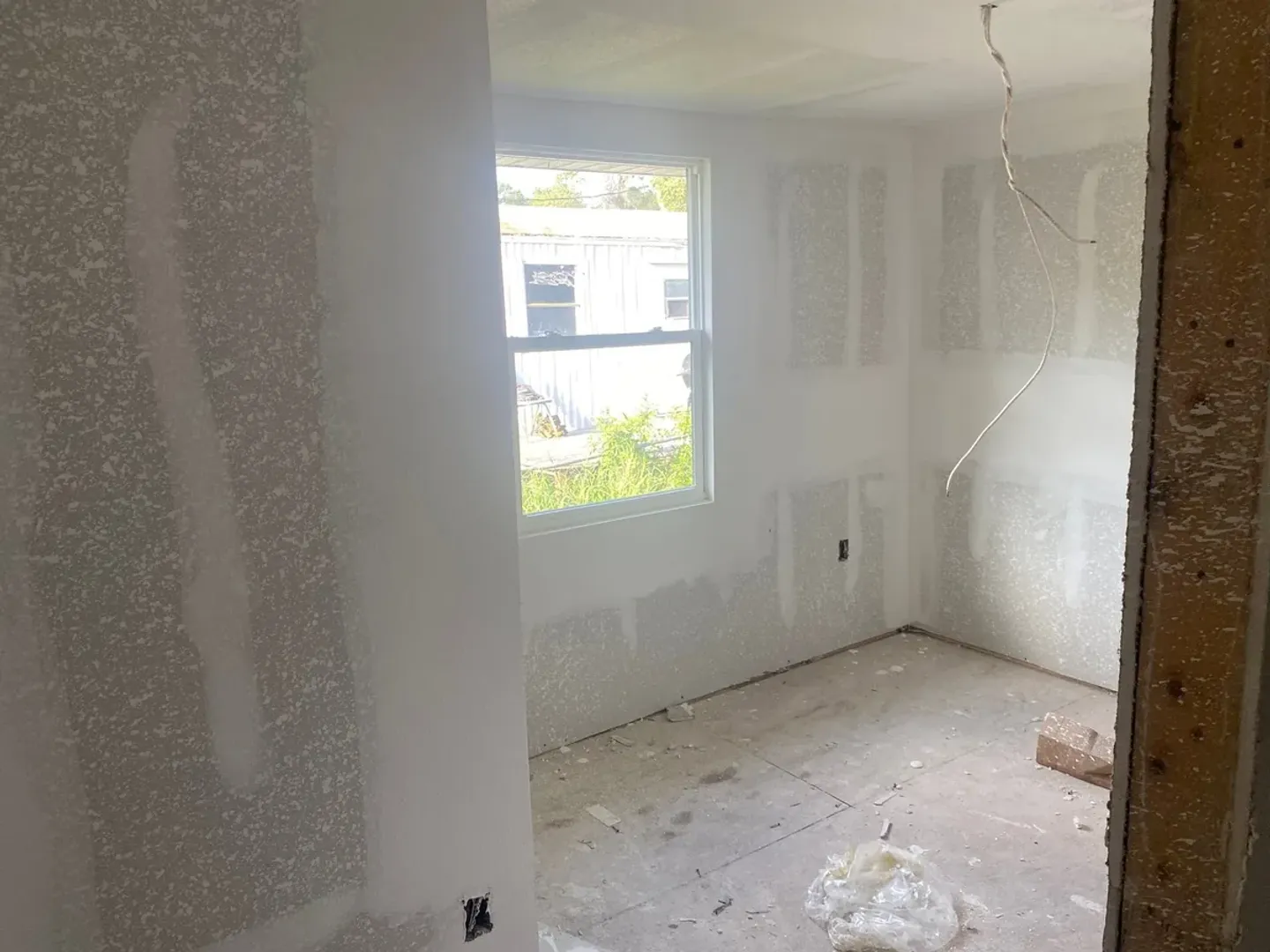 Interior drywall with seams and joint compound in progress.