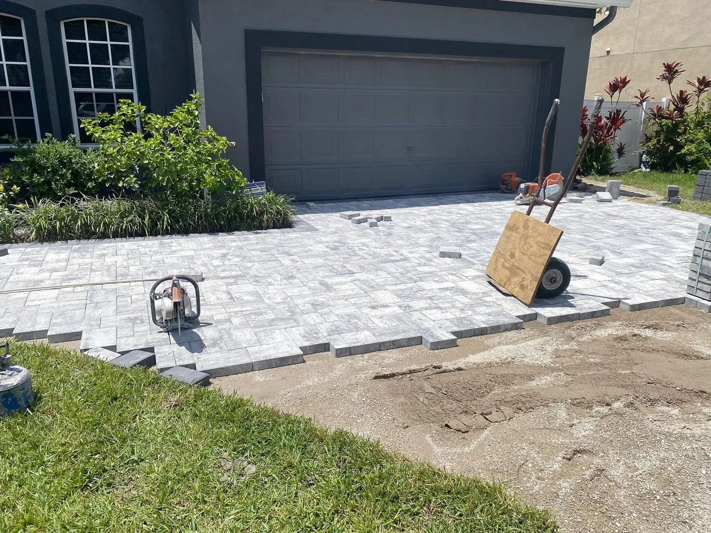 Paver driveway and walkway at different stages of the project.