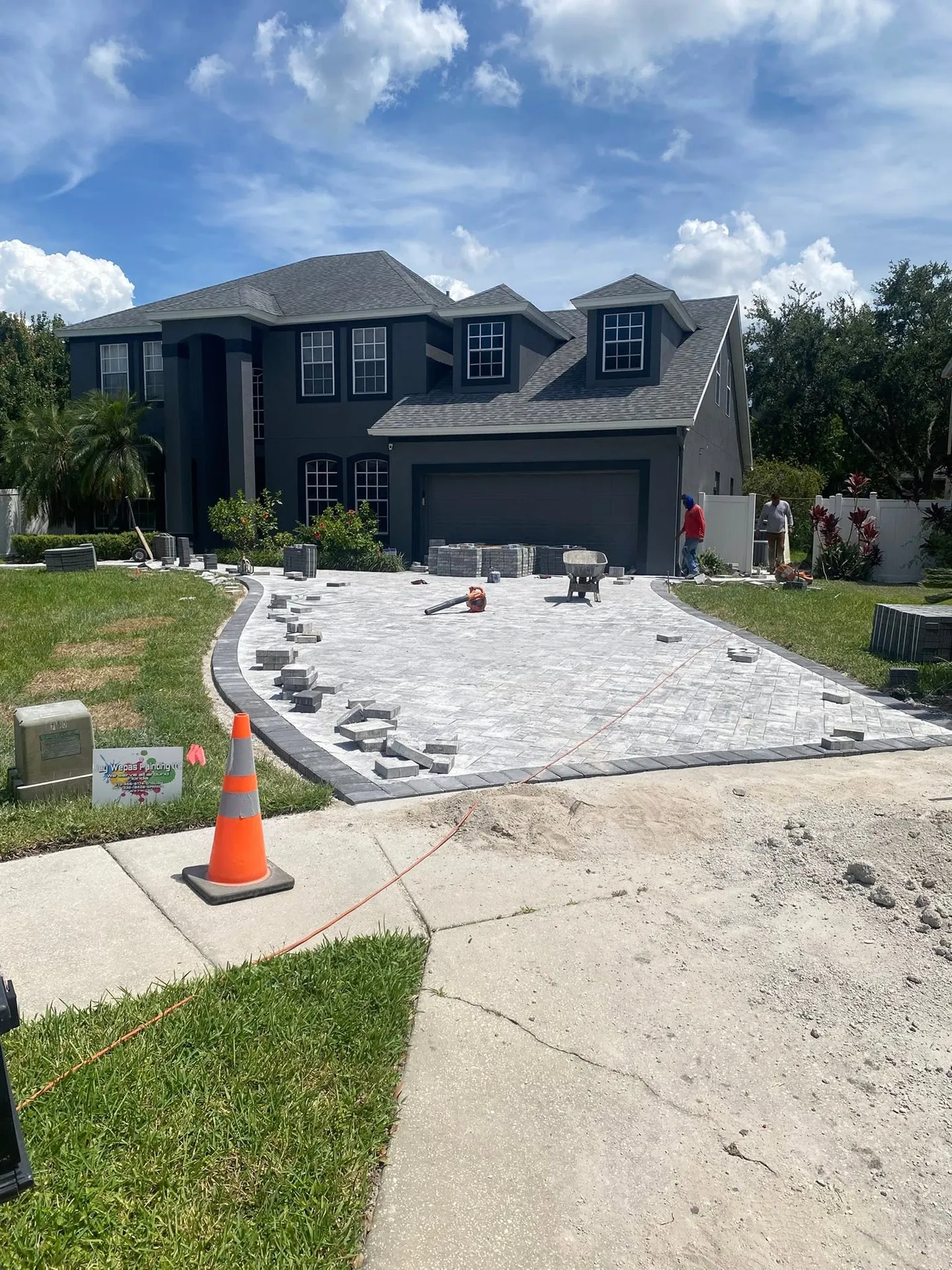 Paver driveway and walkway at different stages of the project.
