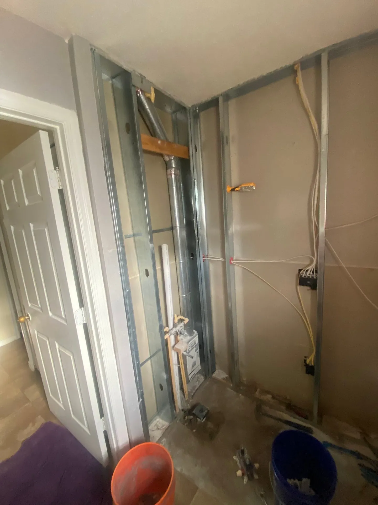 Shower during remodeling and with the finished glass enclosure.