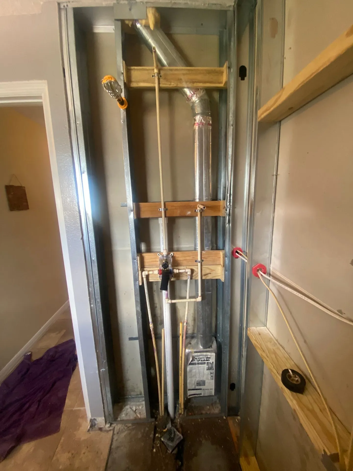 Shower during remodeling and with the finished glass enclosure.