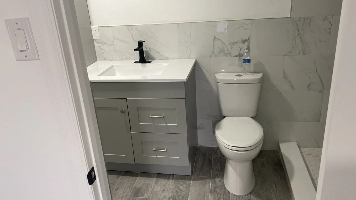 Completed interior, bathroom, door, shelving and exterior improvements.